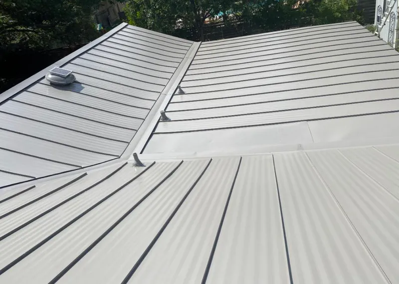 Solar attic fan installed on a metal roof for Roof Ventilation in Lincoln City